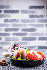 Canvas Print - Fresh vegetable salad with slices of ham , cherry tomatoes lettuce leaves. Ham salad. Take away food.