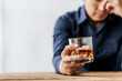 © NanSan - Sad depressed addicted drunk guy, Alone asian man drinker alcoholic sitting at bar counter with glass drinking whiskey.