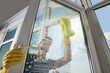 © New Africa - Man cleaning glass with sponge indoors, low angle view