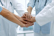 © ASDF - doctors holding hands together at hospital