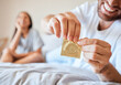 © N Felix/peopleimages.com - Condom, sex and safety for sexual couple in bed together happy, smile and use protection. Happiness, love and man and woman open birth control contraceptive package to protect against std, sti or hiv