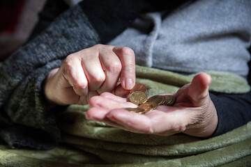 Wall Mural - senior adult or pensioner is sitting with winter clothes indoors