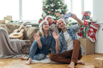 happy family mother, father and child daughter near Christmas tree at home