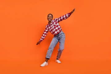 Wall Mural - Full length photo of cheerful nice person dancing chilling spend pastime isolated on orange color background