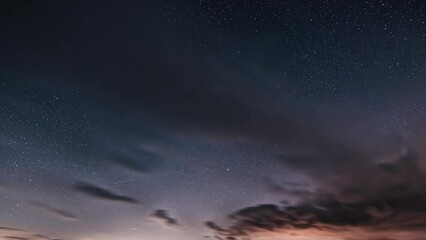 Wall Mural - background of dark starry night sky with stars and clouds motion fast time lapse