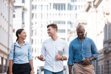 Canvas Print - Business people, friends and city group walking, talking and chatting about work project while outside on an urban street. Diversity, happy and employees planning, traveling and social on commute