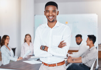 Canvas Print - African businessman smile, during meeting at work while staff talk at table in office or boardroom. Black man happy as corporate leader, workers have conversation or planning new strategy for company