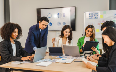 Wall Mural - Mix race young start up business people meeting at office desk in modern workplace.