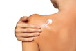 © vladimirfloyd - Close up young woman smearing shoulder with cream. Back view