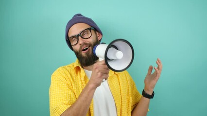 Wall Mural - Funny emotional guy with megaphone, talking proclaiming news, loudly announcing advertisement, hot news announce discounts sale hurry up communication concept. Studio video isolated on blue background