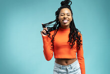 Young Lovable Woman With African Hairstyle Laughing During Indoor Photoshoot. Graceful Cute Girl
