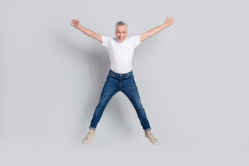 Wall Mural - Full length body size view of attractive cheery crazy lucky man jumping having fun isolated over grey pastel color background