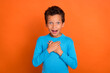 Photo of astonished impressed boy arm breast unexpected unbelievable reaction win winner isolated on orange color background