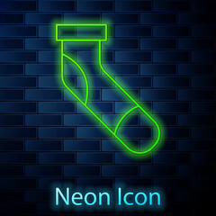 Sticker - Glowing neon line Baseball sock icon isolated on brick wall background. Vector