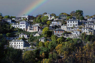 Wall Mural - Autumnal landscape showing the stone houses of traditional architecture in the village of Kipi in Epirus, Greece after heavy rain