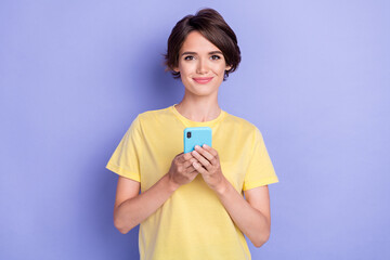 Poster - Photo of pretty charming lady hold use telephone chatting typing isolated on violet color background