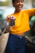 Cheerful black woman showing new car key