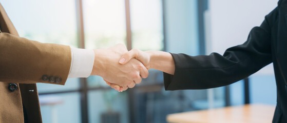 People in the business world concluding their meeting by shaking hands.