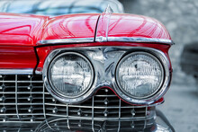 Many Classic Red Vintage Old American Cars Parked In Row At Garage, Exhibition Of Fest. Close-up Detail View Beautiful Retro Oldtimer Vehicle Hood, Headlight, Fender And Shine Chrome Plated Bumper