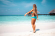 © Vasily Makarov - Young attractive blonde girl with perfect sport body in bikini on the tropical summer beach