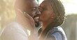 © Marco - Candid African couple together outside at park. Woman kissing man in cheek outside