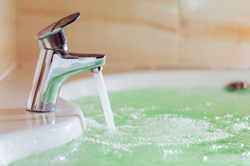 Canvas Print - single handle faucet pouring hot water in a bath tub