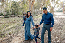 Family Walking Together In Eucalyptus Grove