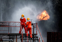 Firefighters Safety Using Twirl Water Fog Type Fire Extinguisher To Fighting With Fire From Oil And Gas To Control Fire Not To Spread Out Firefighter Stop This Accident And Safety Concept.