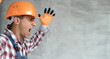 © Andrii Lysenko - Screaming builder in helmet. Young man construction worker in hard hat crazy and mad shouting and yelling with aggressive expression and arms raised. Builder on gray wall background.