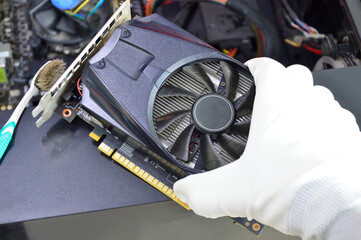 Poster - top view of graphics card technician about to install