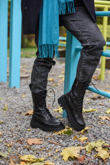 Wall Mural - Slender female feets in military boots. street photo