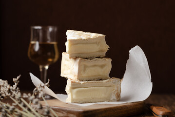 Homemade Vegan cheese on rustic black background. Copy space, close up.