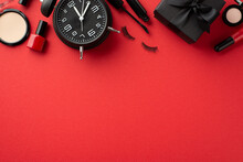 Black Friday Concept. Top View Photo Of Cosmetics Compact Powder Nail Polish Mascara False Eyelashes Eyeshadow Lip Gloss Black Giftbox And Alarm Clock On Isolated Red Background With Empty Space