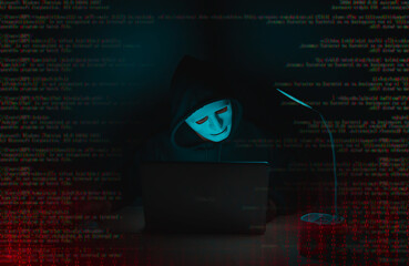 Wall Mural - A hacker in black uses a laptop on a desk to hack a system with binary code.Cyber attack, system breaking and malware concept.