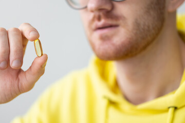 Smiling man takes vitamins. Closeup. Healthcare and medicine.