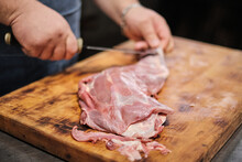A Butcher Butchers A Leg Of Lamb For Grilling. Pitmaster Prepares Meat For Smoking