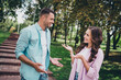 © deagreez - Portrait of two friendly positive people communicate say tell spend free time walking outside