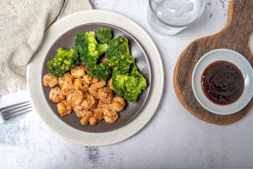 Wall Mural - Shrimp and broccoli, low calorie high protein dish. Sesame seeds in teriyaki sauce. EASY SHRIMP AND BROCCOLI STIR FRY.