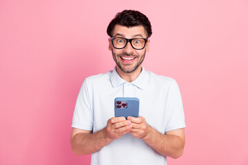 Poster - Photo of positive nice man dressed trendy outfit use telephone enjoy modern device gadget isolated on pink color background