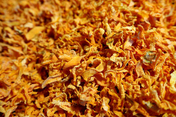 Wall Mural - a lot of orange dried carrots close up.  side view.  dried vegetables.  dry carrot pieces