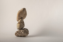 Three Balancing Pebbles On Neutral Background