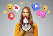 © Syda Productions - communication, social media and people concept - teenage girl speaking to megaphone over internet icons on grey background