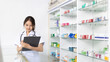 © Puwasit Inyavileart - Pharmacist working in a pharmacy, Consultation and medical advice, All kinds of generic household drugs and pharmaceutical products on the shelf, Service and assistance to patients, Pharmacy.