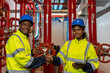 © amorn - Portrait of engineer or technician maintenance, checking, or test system springer prevent fire. Group of African American contractor checking fire sprinkler system, pipe assembly, red fire pipe