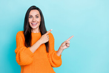 Poster - Photo of positive nice girl toothy smile indicate fingers empty space isolated on aquamarine color background