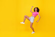 Leinwandbild Motiv Full length portrait of excited carefree lady dance sneaky walking look empty space isolated on yellow color background