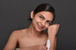 © Karan - A young woman using hair removal cream with spatula