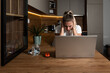 © Srdjan - Exhausted upset young student girl sitting at table with laptop, leaning head on hand, suffering from headache, feeling depressed, unhappy, tired, getting bad news. Professional burnout concept