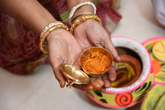 Showing of haldi or turmeric paste in Indian bengali marriage ceremony.