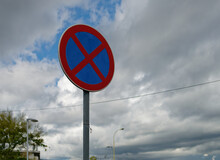 Close-up Photo Of No Parking Traffic Sign With The Cloudy Sky In The Background